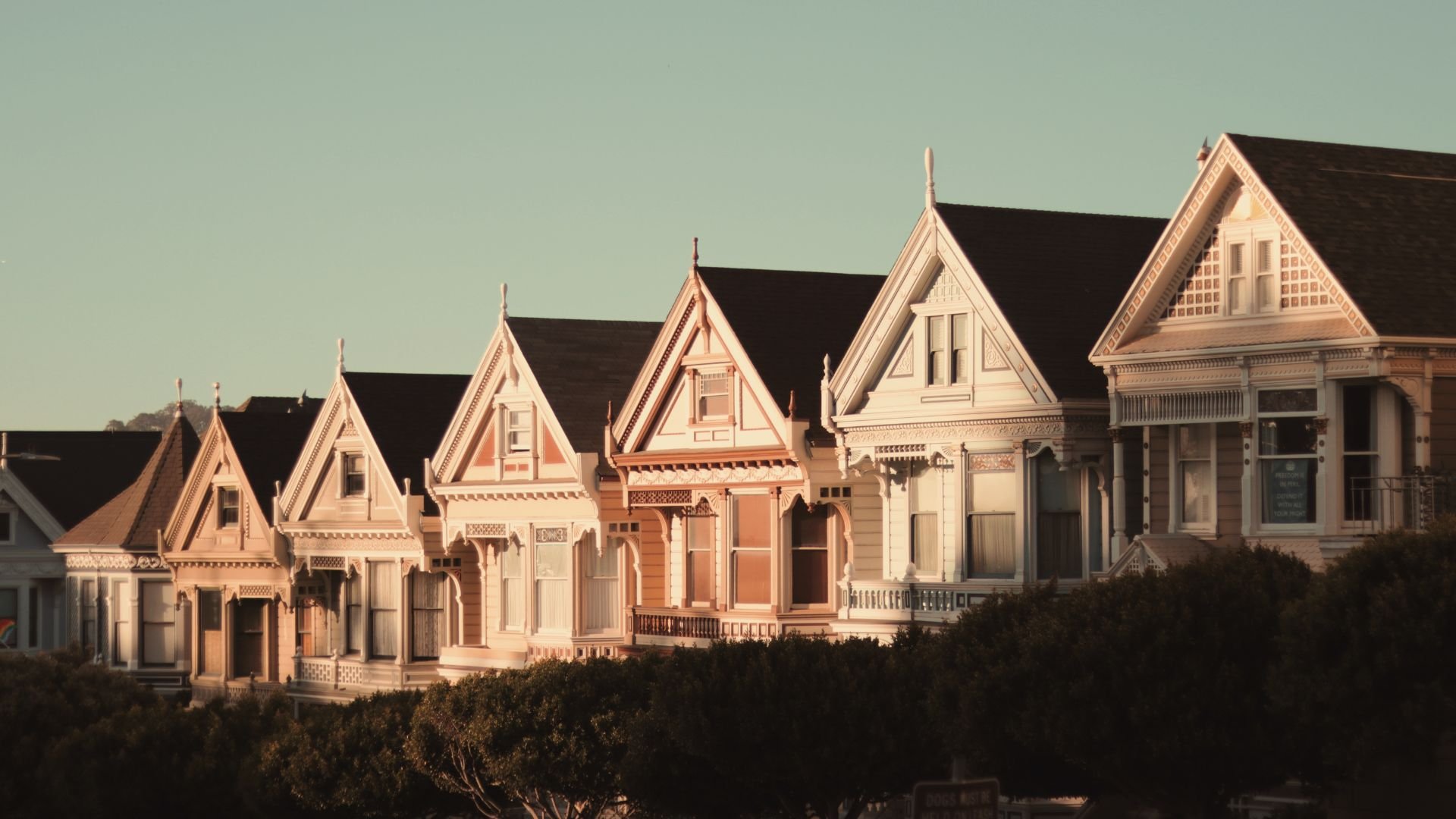 Row of Victorian houses in soft light with decorated gables and trim